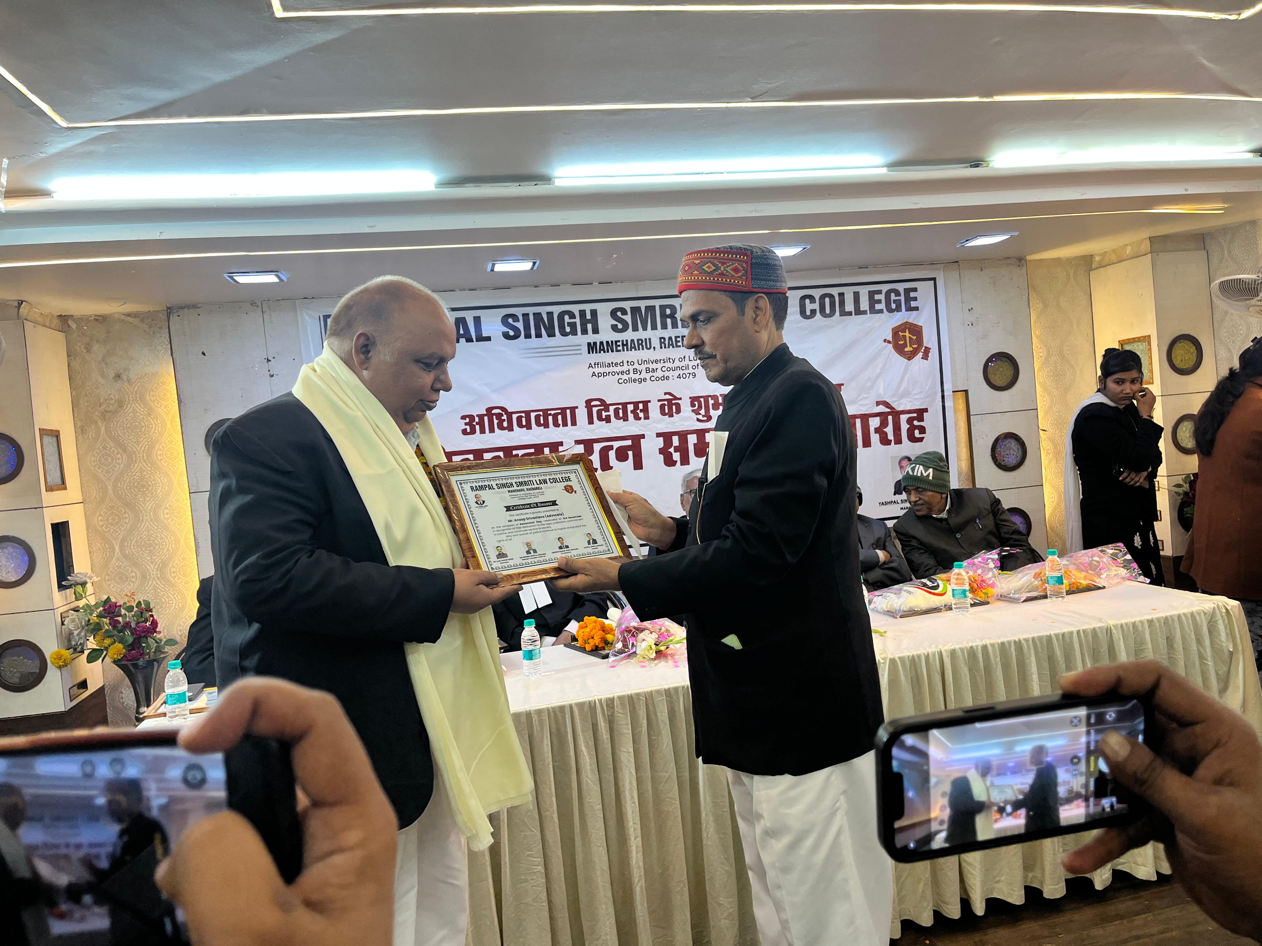 Senior advocate receiving certificate with dignitaries