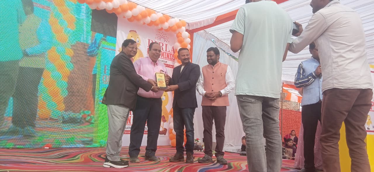 Advocate receiving memento on a public stage